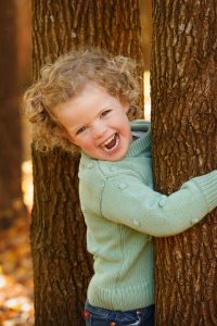 Girl behind tree in Gisborne
