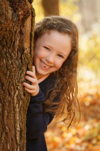 Girl behind a Tree in Gisborne