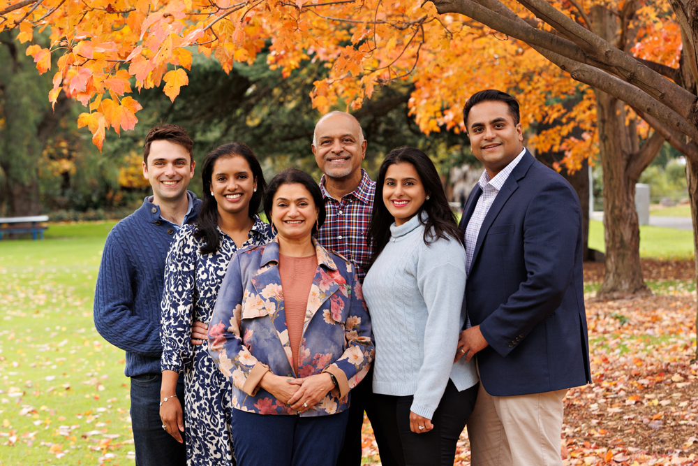 Family standing at Queens Park Autumn