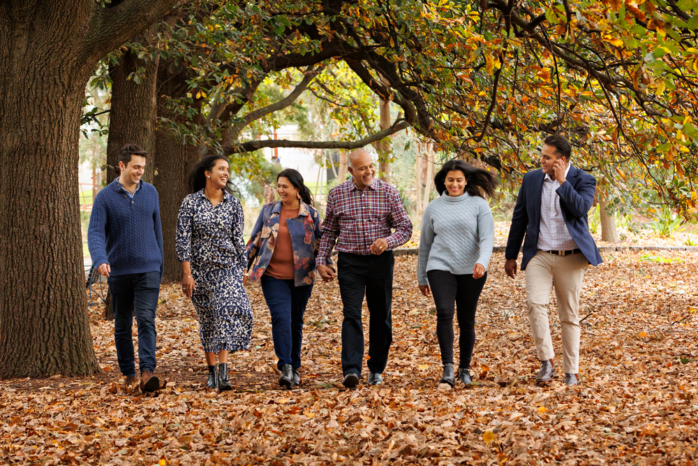 Autum Family walking in Queens park