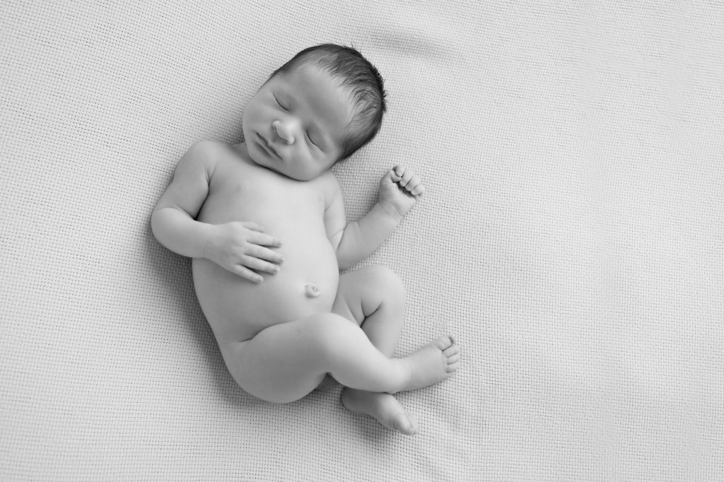 newborn boy on his back