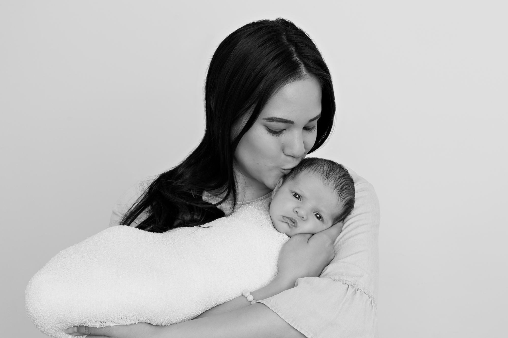 mother kissing newborn Newborns of Melbourne Photography Session