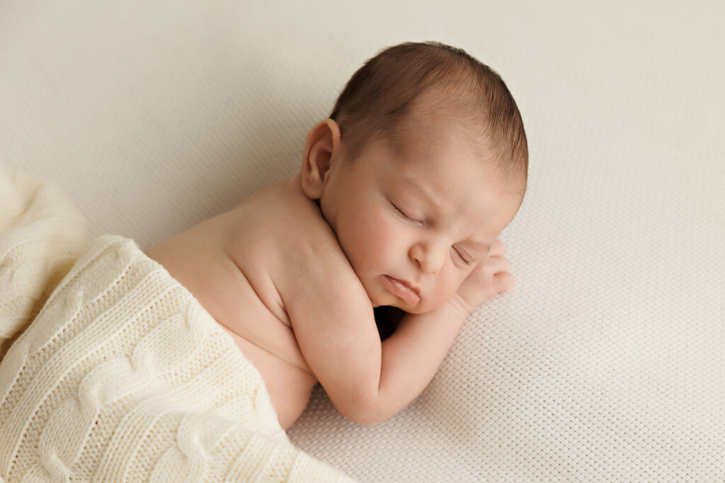Newborn girl sleeping on her side in blanket In-Home Newborn Photography in Aintree